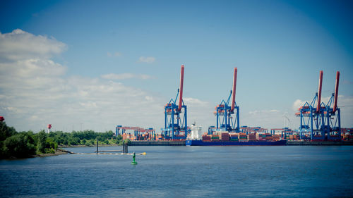 Commercial dock by sea against sky