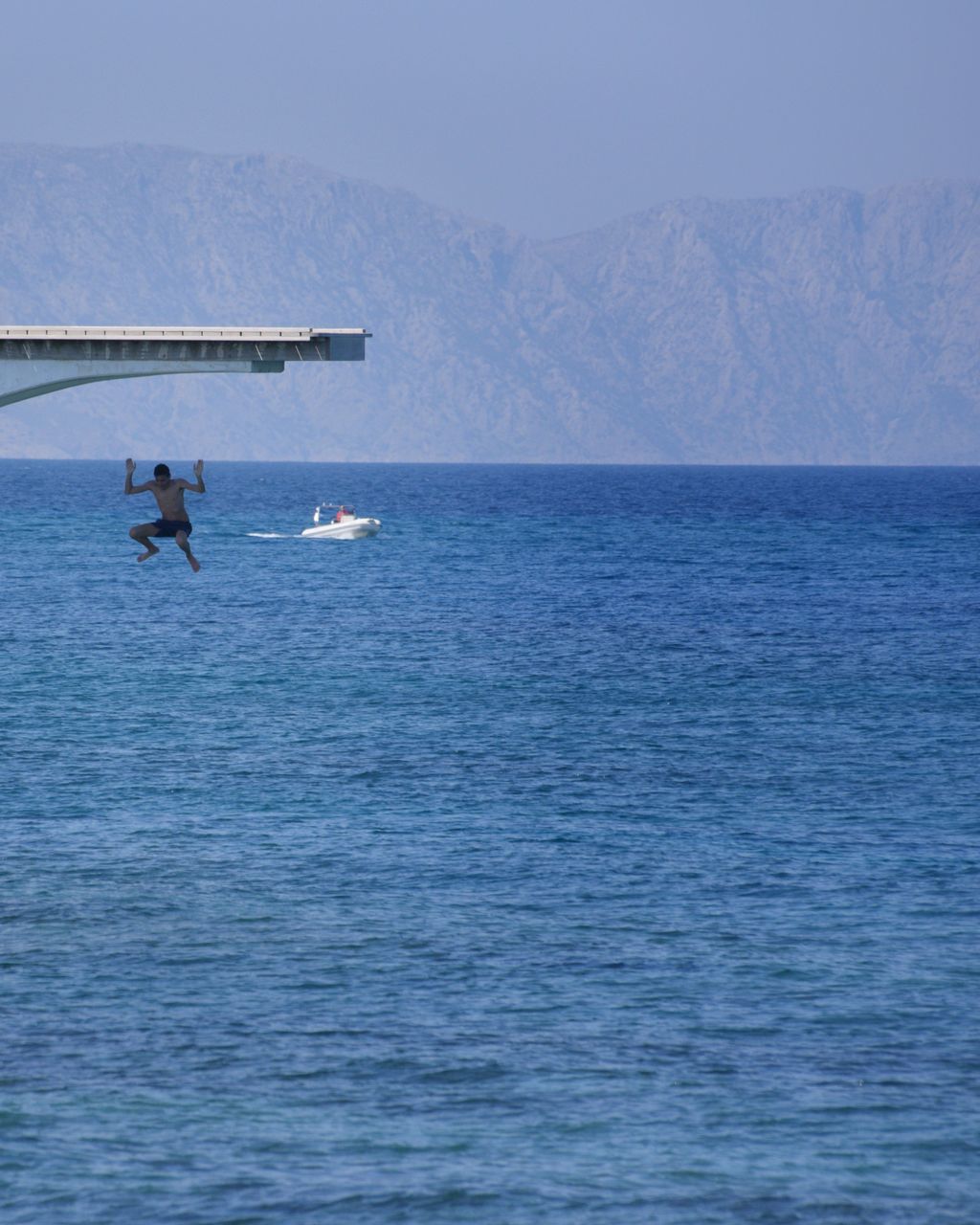 MAN ON SEA AGAINST SKY