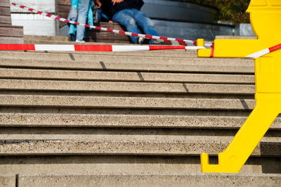 Cordon tape over steps against friends on seat