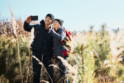 Couple having video call sending greetings from vacation trip. leisure time close to nature