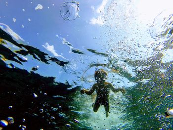 Low angle view of boy swimming underwater