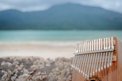 Close-up of pebbles on beach against sky