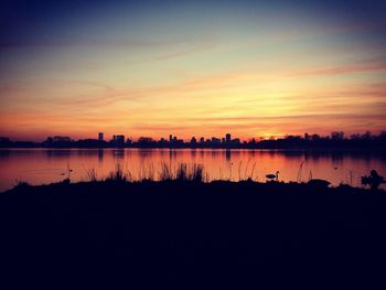 Scenic view of lake against sky during sunset