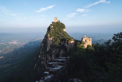 Castle on mountain against sky