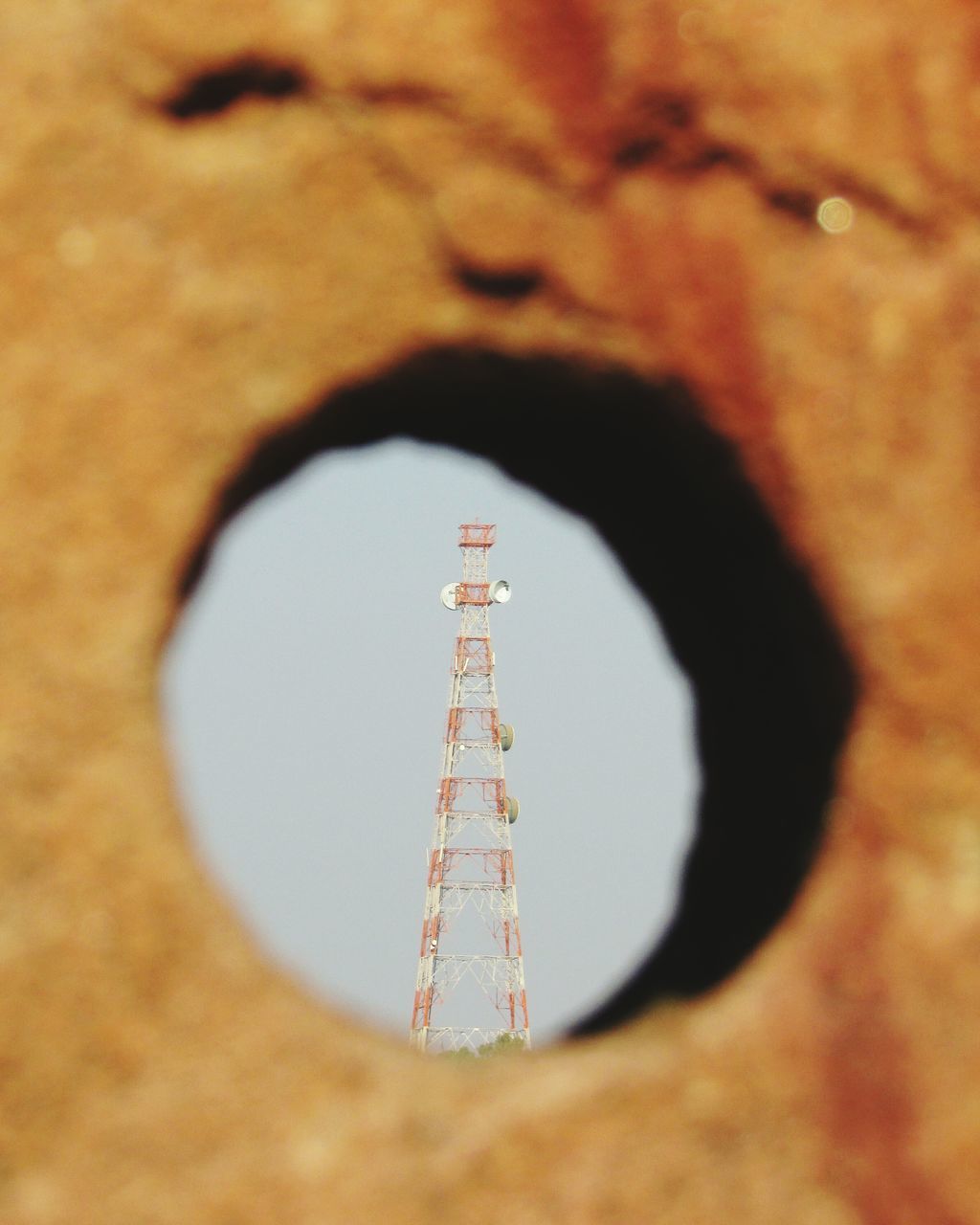 circle, low angle view, close-up, communication, indoors, arts culture and entertainment, technology, leisure activity, sky, focus on foreground, sphere, built structure, tall - high, day, tower, metal, architecture