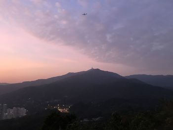 Scenic view of silhouette mountains against sky at sunset