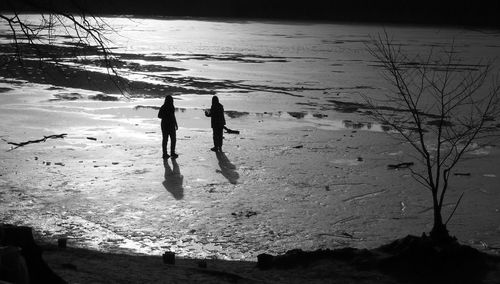 High angle view of silhouette people on beach