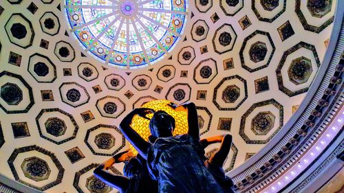 Low angle view of woman on ceiling