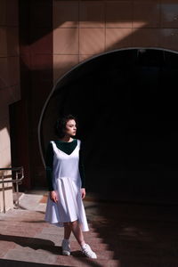Full length portrait of woman standing on floor