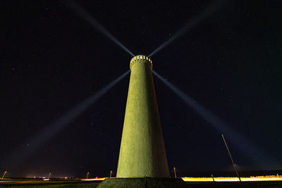 Low angle view of illuminated building against sky at night