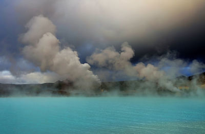 Smoke emitting from clouds over water