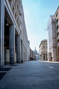 Surface level of road amidst buildings against sky