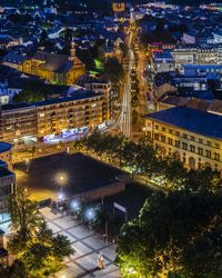 High angle view of city lit up at night
