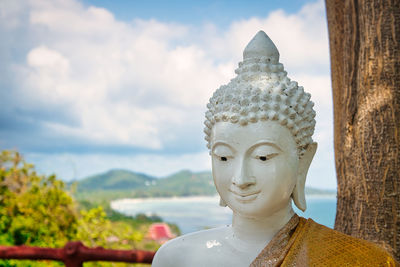 Statue of buddha against sky