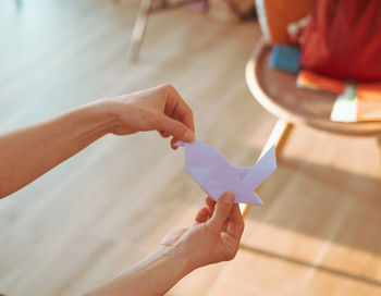 Cropped hands of man holding paper