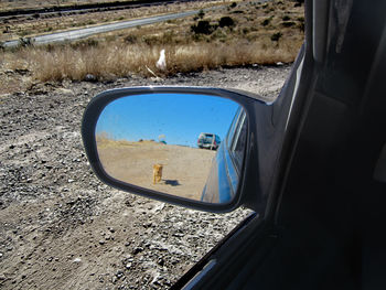 Reflection of car on side-view mirror