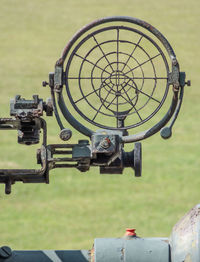 Close-up of old machinery on field