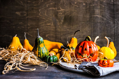 Autumnal table setting with bright pumpkin on rustic background with copy space