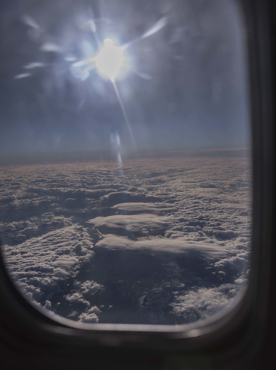 AERIAL VIEW OF CITYSCAPE SEEN THROUGH WINDOW