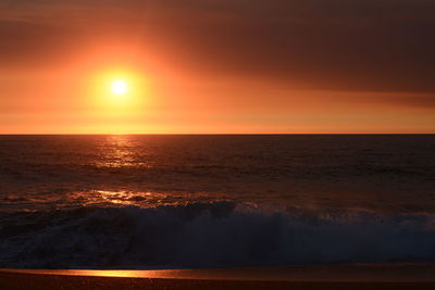 Scenic view of sea against orange sky