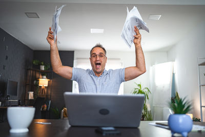 Portrait of man using laptop while sitting at home