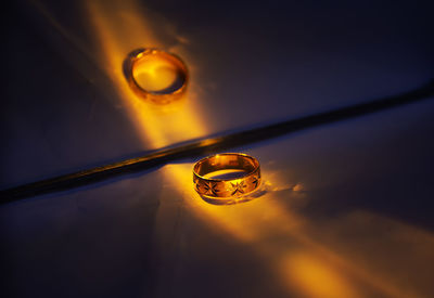 Close-up of water drops on glass against sky during sunset