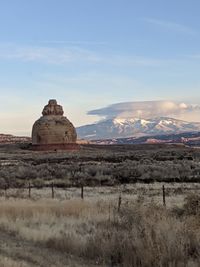 Rock formations on landscape against sky