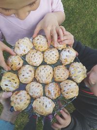 People holding cookies in tray