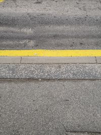 High angle view of yellow road sign on street