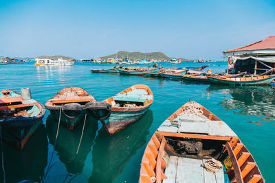 Boats moored in sea against sky