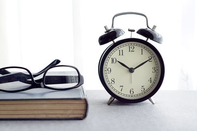 Close-up of clock on table