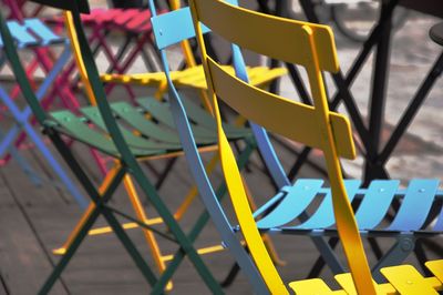 Close-up of multi colored chairs at outdoors cafe