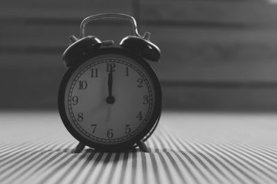 Close-up of clock on table