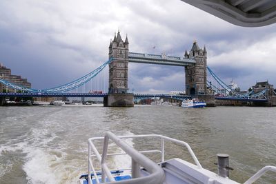 View of bridge over river against cloudy sky