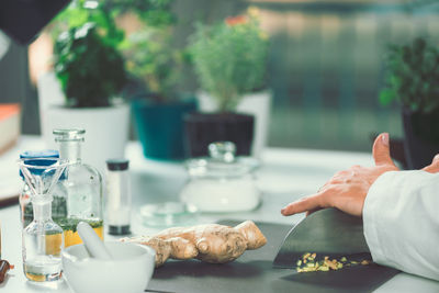 Cropped image of female chef preparing food in commercial kitchen