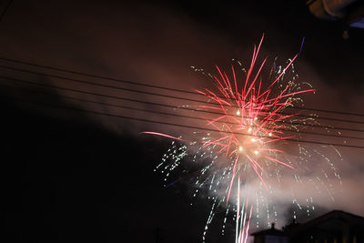 Low angle view of firework display at night