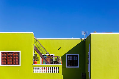 Low angle view of house against clear blue sky