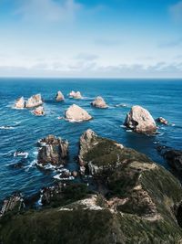 Rock formations in sea against sky