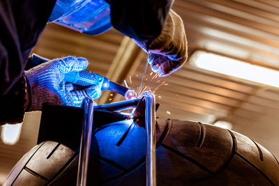 Close-up of welder welding equipment in workshop