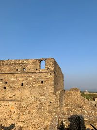 Old ruin building against blue sky