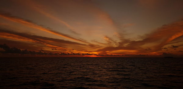Scenic view of sea against romantic sky at sunset