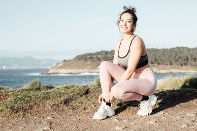 Portrait of young woman sitting on beach