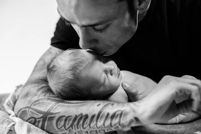 Close-up of father kissing daughter at home