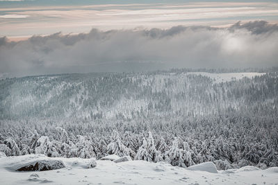 Scenic view of snow covered land against sky