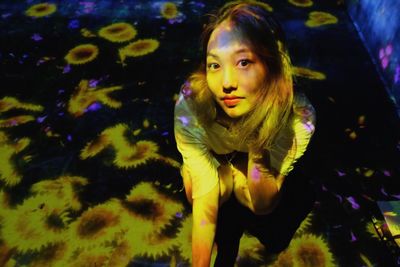 Portrait of young woman in aquarium