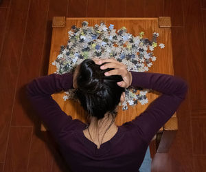 High angle view of woman sitting on wooden floor