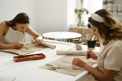 Pottery workshop in studio. people working with clay on the table. adults learning to do ceramic