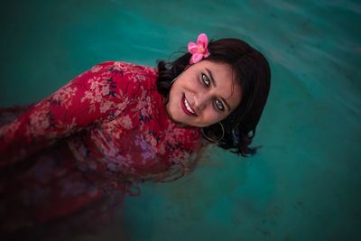 Portrait of a young woman in swimming pool