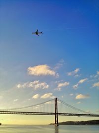 Low angle view of suspension bridge against sky