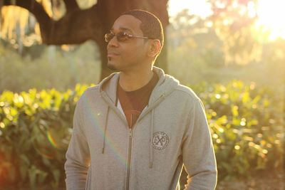 Man standing in sunglasses on field